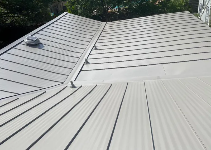 Solar attic fan installed on a metal roof for Roof Ventilation in Woodland